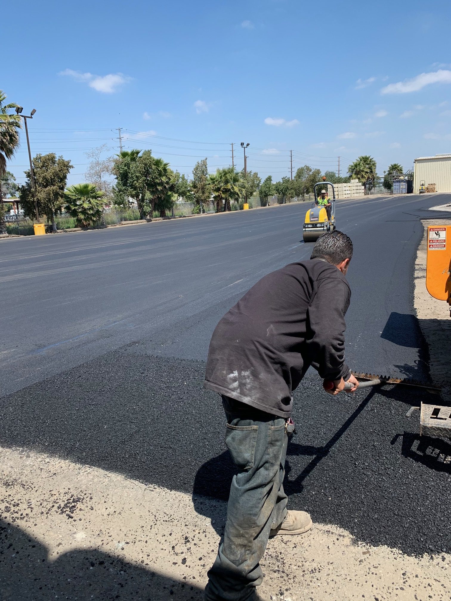 A man is working on tarring the road